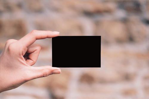 Hand Holding Black Card Mockup
